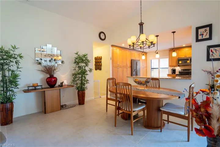 Dining area featuring light tile patterned floors and a notable chandelier