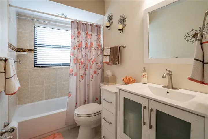 Guest bathroom with vanity, shower / bath combination