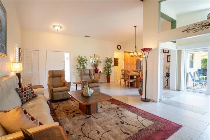 Tiled living room featuring a towering ceiling