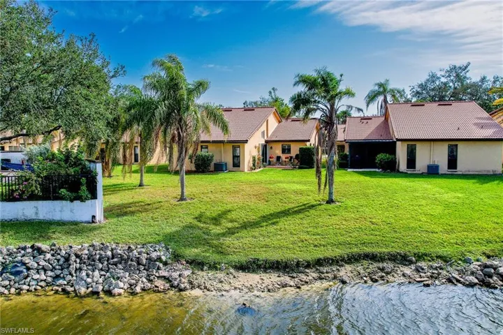 Back of property featuring a yard, a water view