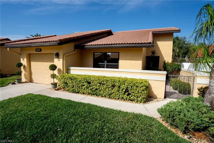 Mediterranean / spanish house featuring a garage