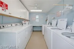 Laundry room featuring cabinets, independent washer and dryer, and ceiling fan