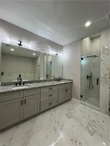 Bathroom featuring vanity and a shower with shower door