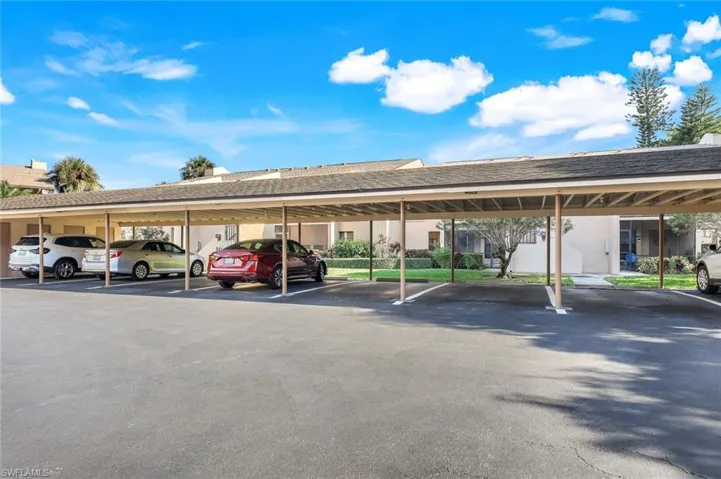 View of parking with a carport