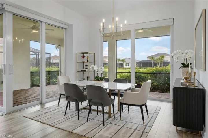 Wood-finish flooring with an open-concept dining area featuring a modern chandelier