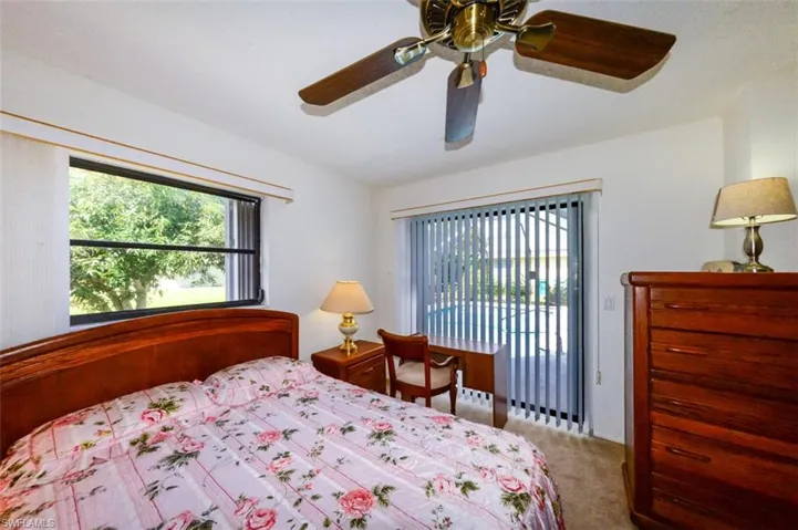 Carpeted bedroom 3 featuring access to lanai and ceiling fan
