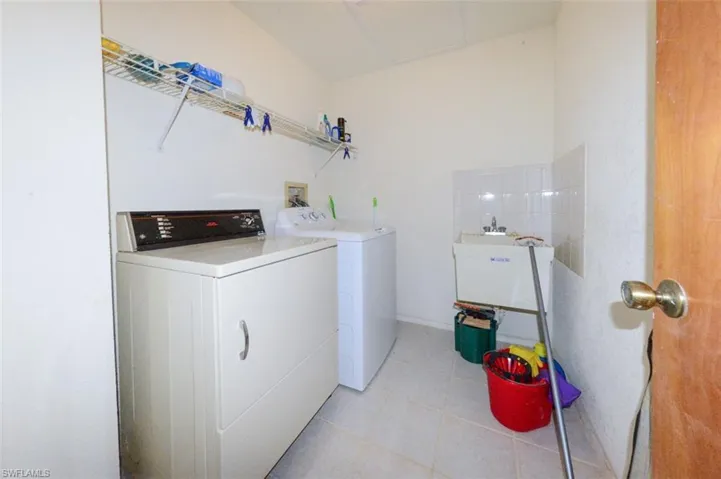 Laundry room featuring separate washer/dryer and sink