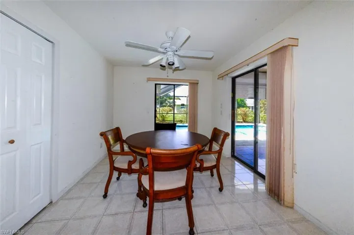 Dinette room featuring ceiling fan and sliders to lanai
