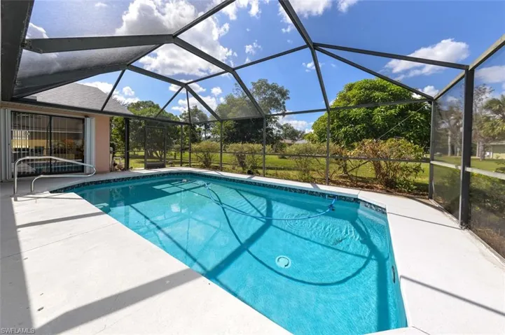 View of swimming pool with a patio area and a lanai