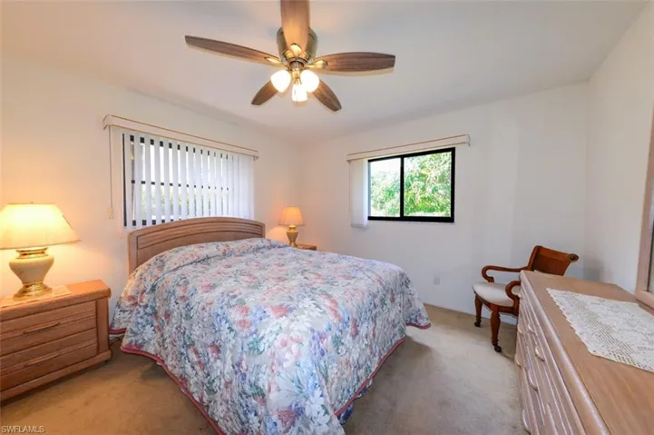Carpeted bedroom 2 with ceiling fan