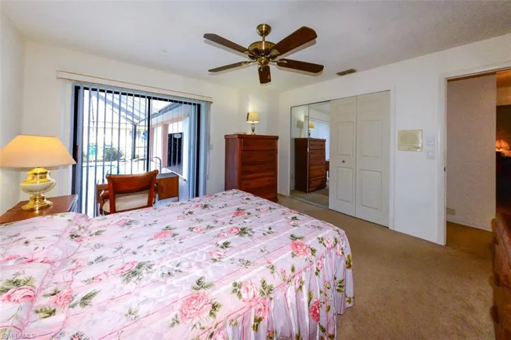 Carpeted bedroom 3 featuring a closet, ceiling fan, and access to exterior