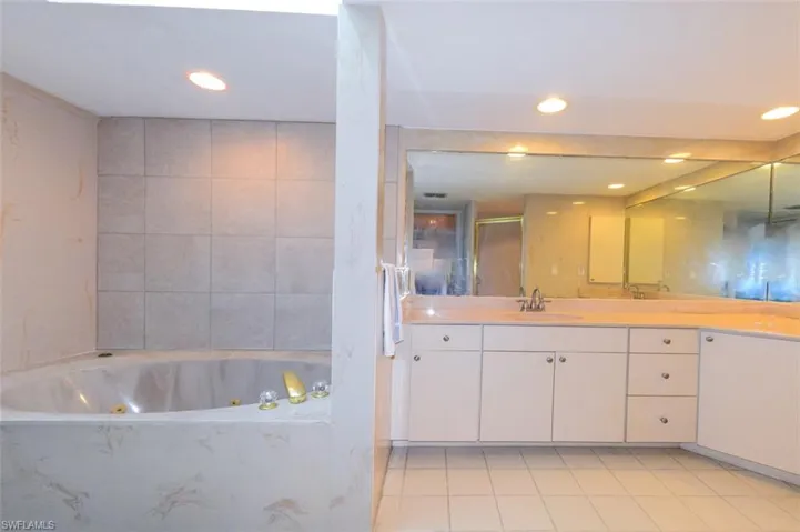 Bathroom featuring vanity, separate shower and tub, and tile patterned floors