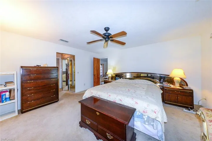 Carpeted bedroom with ceiling fan