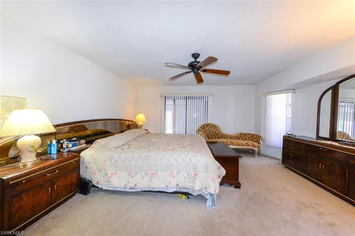Bedroom featuring light colored carpet and ceiling fan