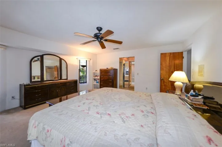 Carpeted bedroom featuring ceiling fan