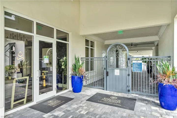 Doorway to property featuring a gate and stucco siding