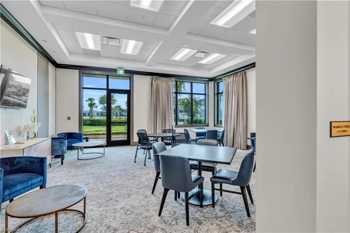 Dining room with carpet floors and coffered ceiling