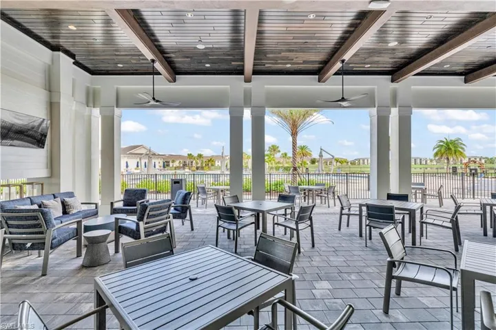 View of patio with ceiling fan, outdoor lounge area, and a residential view