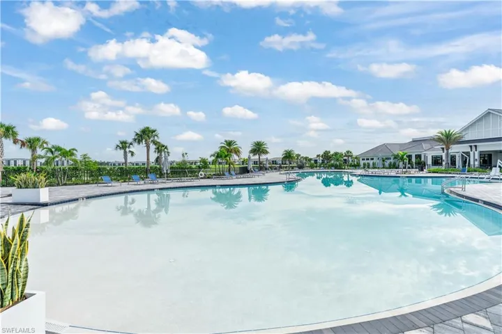 Community pool with a patio