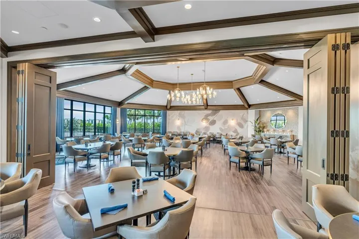 Dining room with crown molding, suspended lighting, wood finished floors, and coffered ceiling