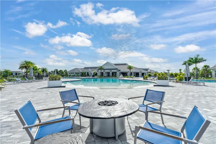 Community pool with a patio and an outdoor fire pit