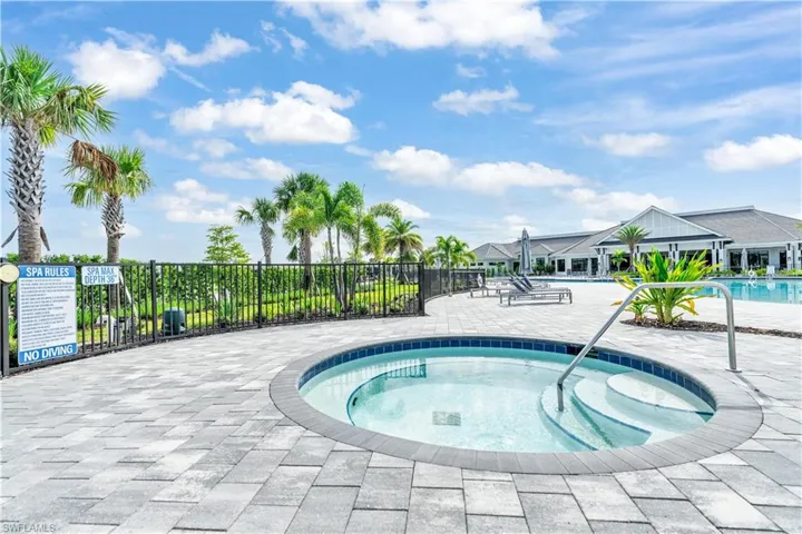 Community pool with a hot tub and a patio area