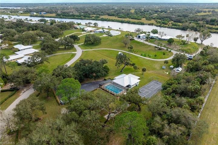 Community pool, clubhouse, and tennis court.