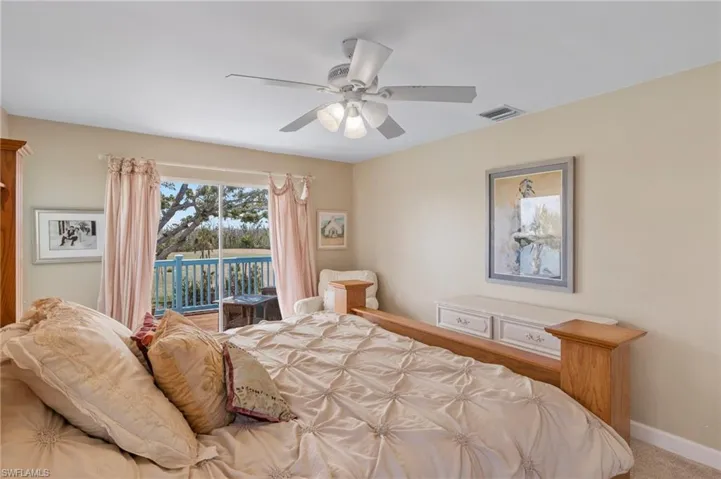 Bedroom with access to exterior and ceiling fan
