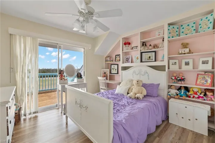 Bedroom featuring light wood-style floors, access to outside, and ceiling fan