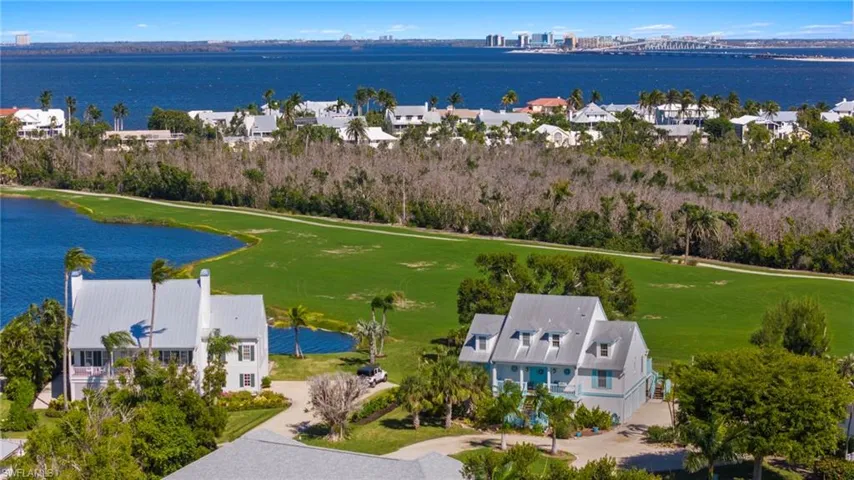 Aerial perspective of suburban area with a nearby body of water