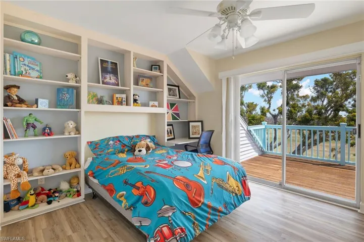 Bedroom with light wood-type flooring, access to outside, and a ceiling fan