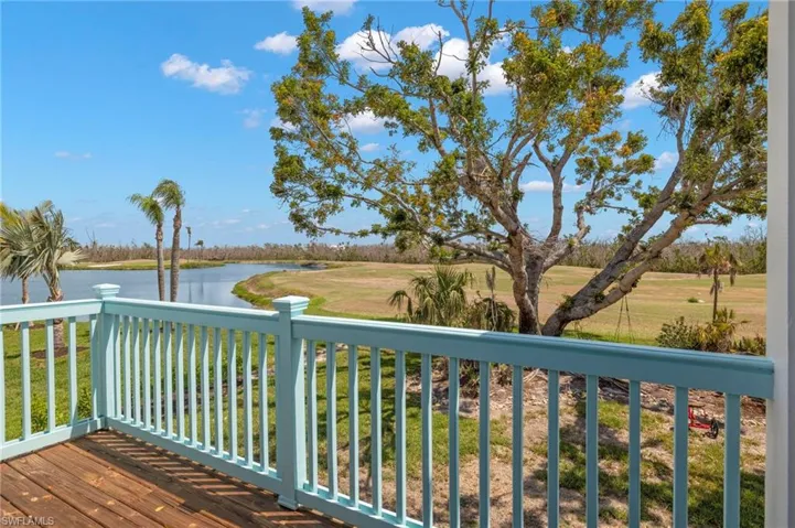 Wooden deck with a water view and a yard