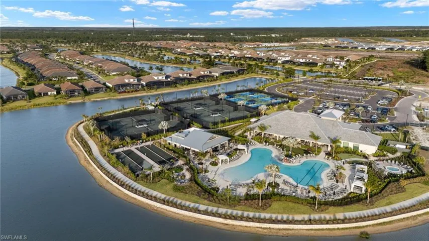 Aerial view of property and surrounding area featuring nearby suburban area