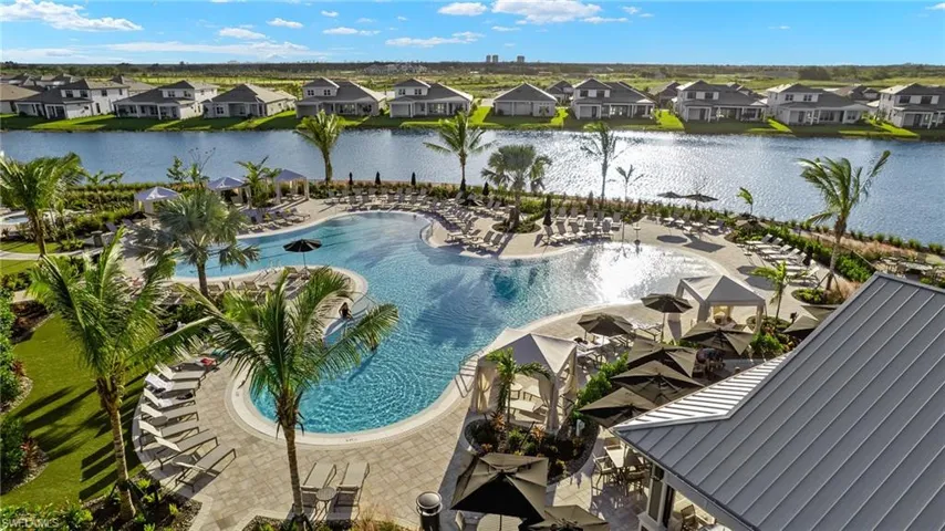 Community pool featuring a patio, a water view, and a residential view