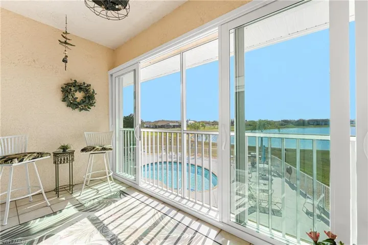 Sunroom featuring a water view