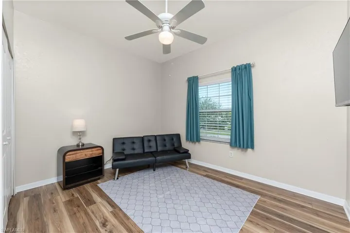 Sitting room featuring hardwood / wood-style floors and ceiling fan
