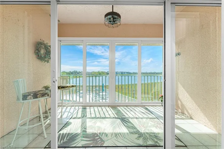 Sunroom featuring a water view