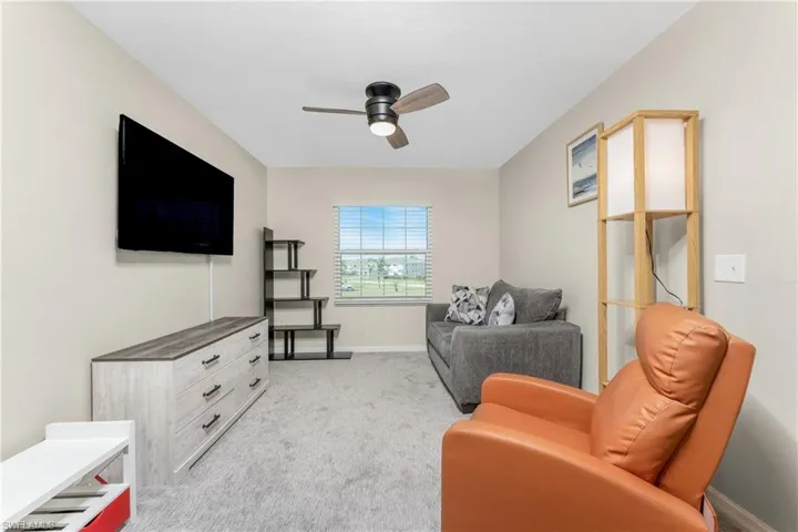 Bonus room featuring light carpet and ceiling fan