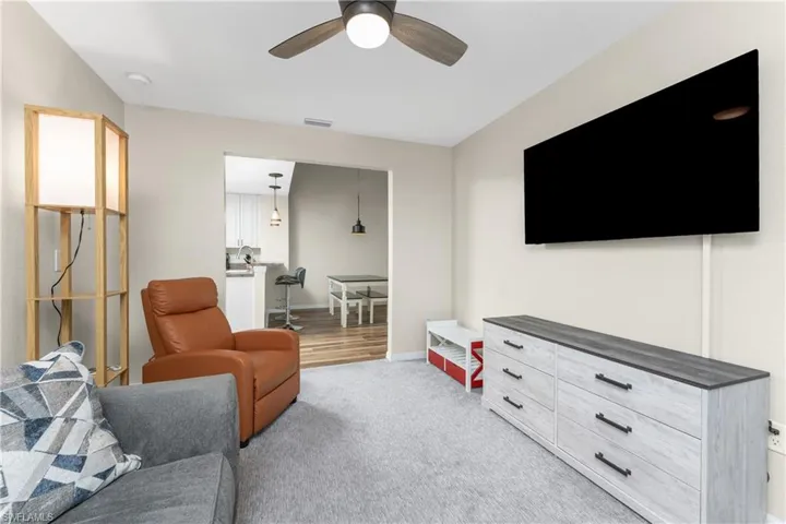 Carpeted Bonus Room featuring ceiling fan