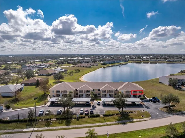 Birds eye view of property with a water view and a residential view