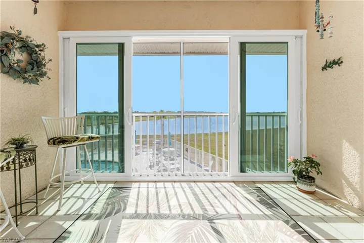 Unfurnished sunroom featuring a water view