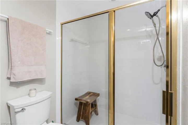 Bathroom featuring toilet and an enclosed shower