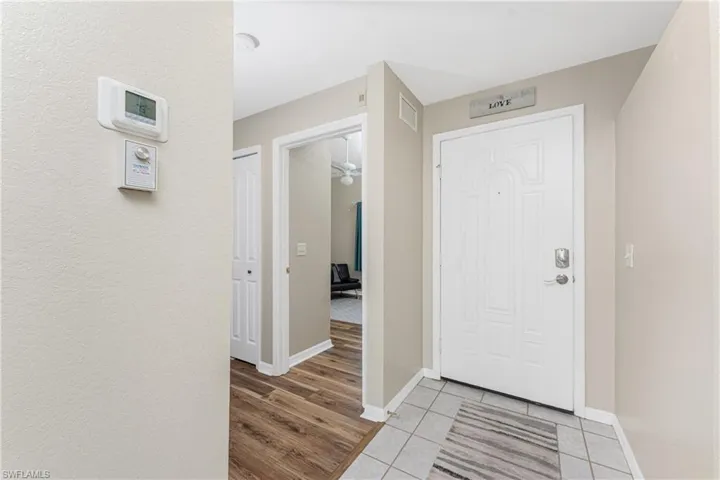 Entrance foyer with light tile patterned flooring