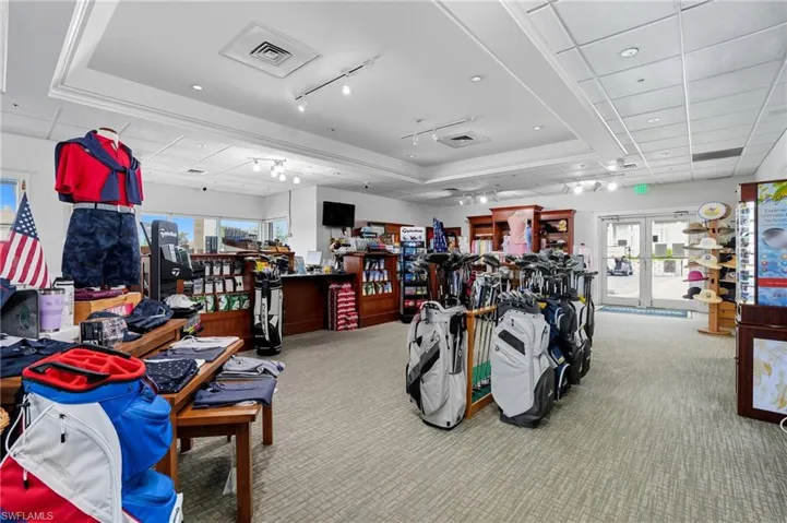 Retail interior featuring light-toned carpet flooring and a mix of recessed and track lighting