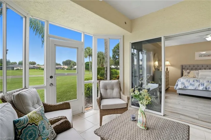 Screened sunroom featuring ceramic tile flooring and floor-to-ceiling windows