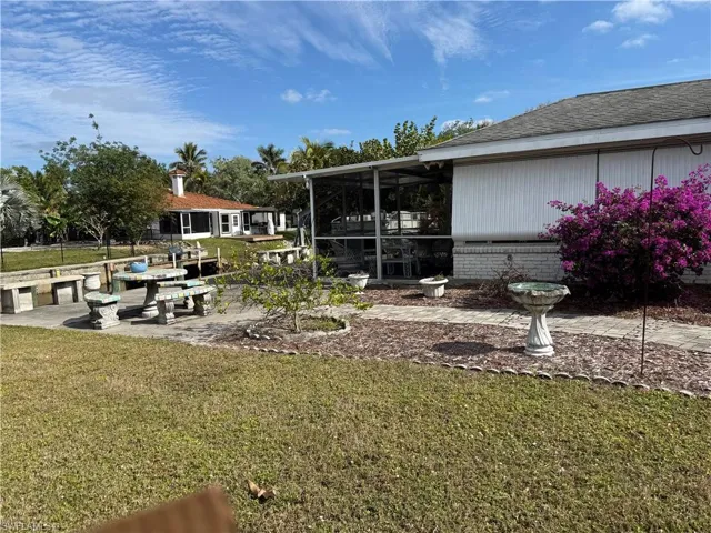 View of yard featuring a sunroom