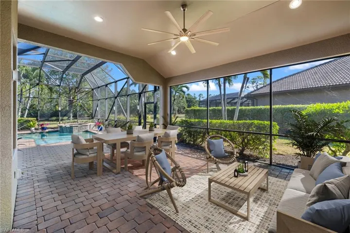View of patio / terrace with glass enclosure, ceiling fan, an outdoor hangout area, and a pool with hot tub