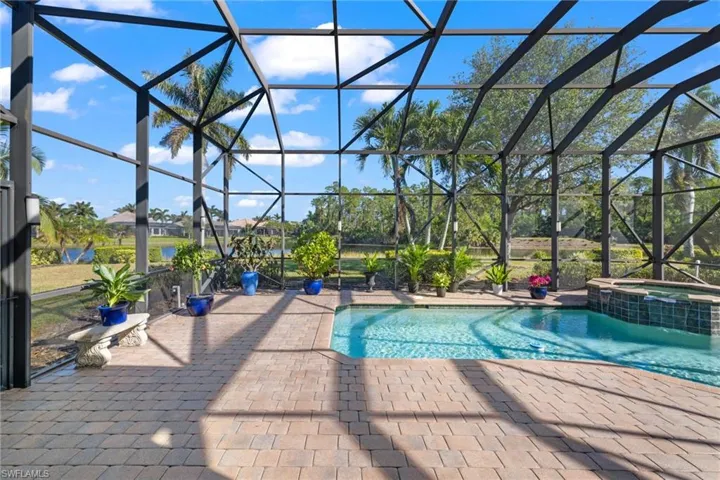 View of pool with a lanai, a patio area, and an in ground hot tub