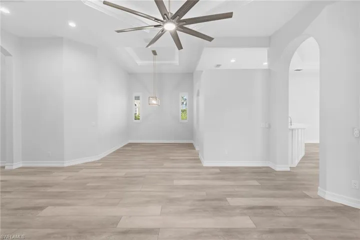 Unfurnished room with ceiling fan and light wood-type flooring
