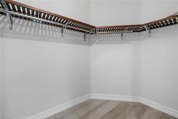 Spacious closet featuring hardwood / wood-style flooring